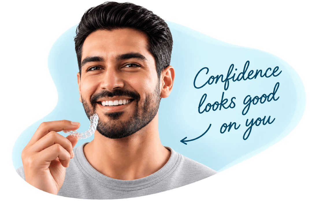 Smiling man holding a clear aligner